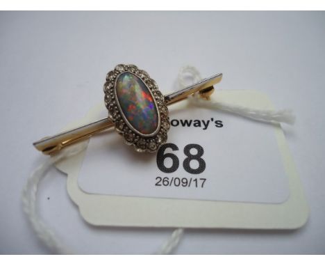 An opal and diamond brooch, the oval opal in millegrain mount, within a border of eight cut diamonds, the whole to a knife ed