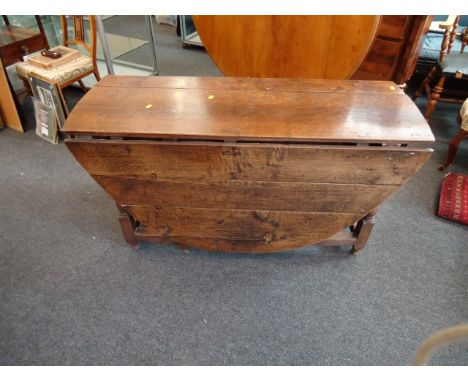 A late 17th century oval oak gate leg table, raised on a turned frame base, 137.5cm long