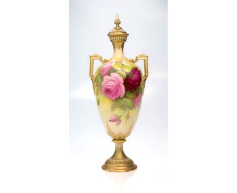An Etruscan form twin handled Royal Worcester vase and cover, with spear finial, decorated with pink roses and foliage on a b