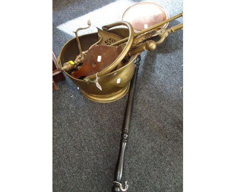 A collection of 19th/20th century brass and copper hearth items, including bed warming pan, bellows, fireside tools and scutt