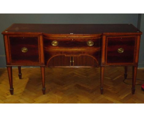 An Edwardian mahogany satinwood crossbanded and strung sideboard, the breakfront rectangular top over frieze drawer and tambo