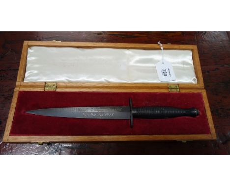 A cased presentation Fairburn Sykes fighting knife (third pattern), the blade with inscription to 2nd Lt M Wickham R.A.O.C. C