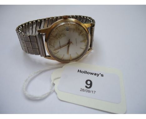 Garrard, a gentleman's 9ct gold wristwatch, the brushed champagne dial with baton numerals, sweep seconds head and date adjus