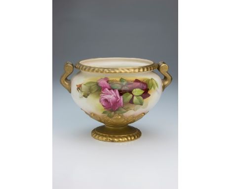 A Royal Worcester twin handled footed bowl, decorated with pink roses and foliage on a blush and gilded ground, gadrooned cir