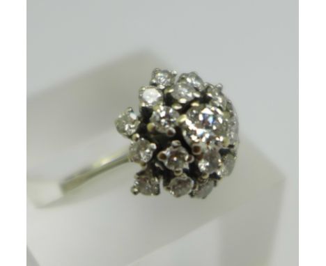 A white metal, diamond set Art Deco ring, with nineteen diamonds in total, the centre stone approximately 0.5carat weight, ov