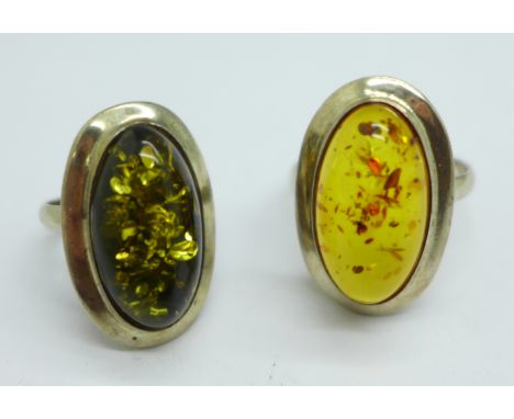 A silver and green amber ring and a silver and amber ring 