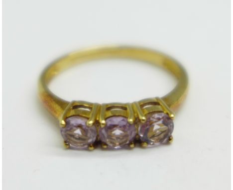 A 9ct gold, three stone amethyst ring, 2g, N 