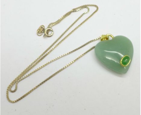 A silver gilt and jade pendant 