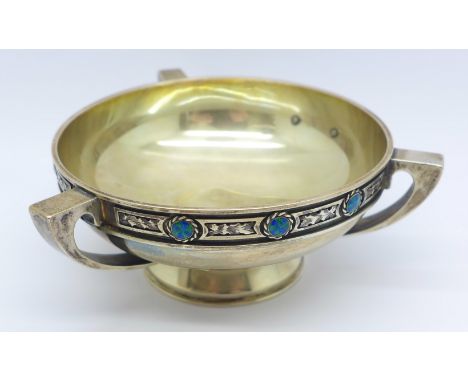 A white metal Arts and Crafts three handled bowl/dish decorated with eight small circular enamel plaques, with inscription an