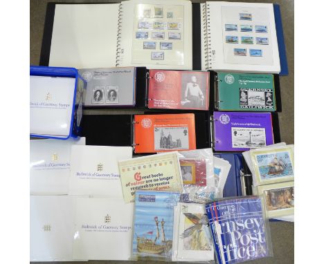 A large collection of Guernsey stamps; 14x yearbooks of mint stamps 1985-1998, a Lindner   album of mint stamps 1969-1988, a 