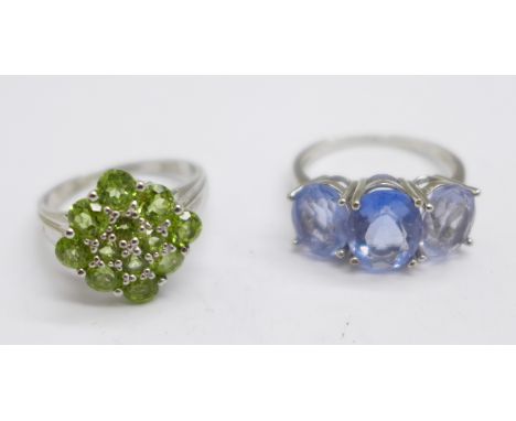 A silver and blue stone ring and a silver and peridot ring 