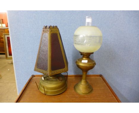 A brass oil lamp and one other oil lamp with red glass shade, one glass panel missing