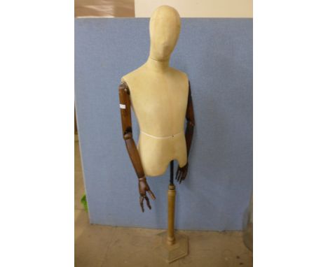 An articulated mannequin on stand