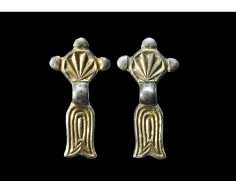 4th-5th century AD. A matched pair of bow brooches each with discoid headplate, shallow bow and fishtail footplate; the headp