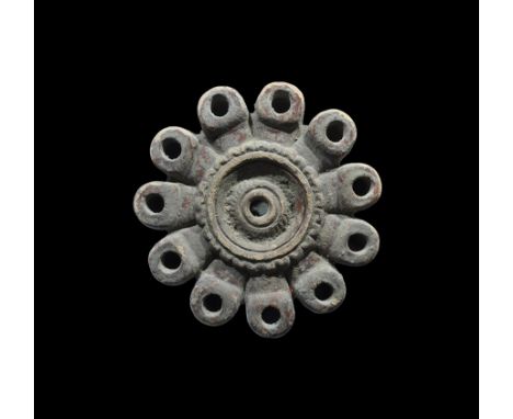3rd-4th century AD. A ceramic oil lamp comprising a segmented bowl with filler howl to the upper face with rosette and concen