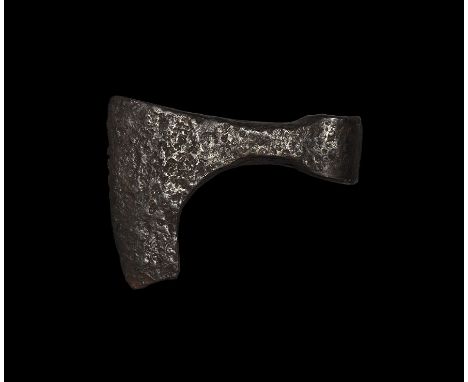 9th-11th century AD. An iron axehead with triangular-section blade widening to a broad bevelled edge with square chin, rounde