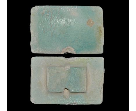 Old Kingdom, 2686-2181 BC. A rectangular pale blue glazed composition tile with slightly domed face, partially pierced rectan