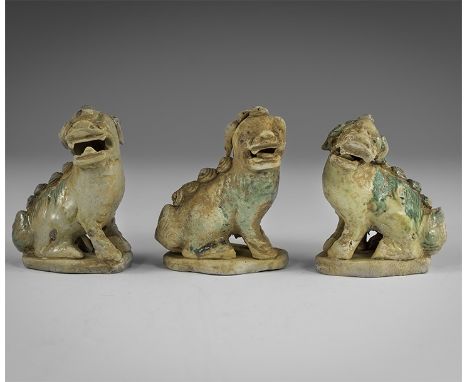 Kangxi Period, Late 17th century AD. A group of three green-glazed ceramic figurines of crouching lions each with the head tu