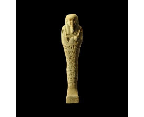 26th Dynasty, 664-525 BC. A pale blue glazed composition shabti with finely modelled facial details, false beard and agricult