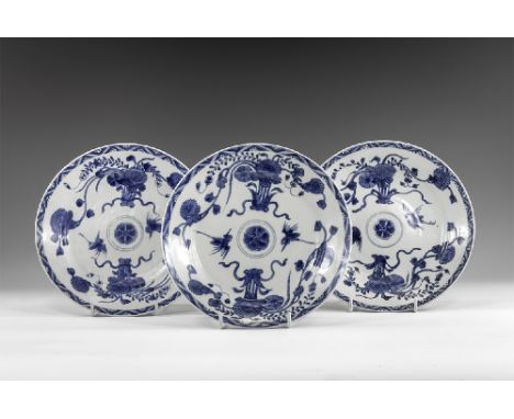 Kangxi Period, Late 17th century AD. A group of three blue and white glazed ceramic dishes with flower and tendril decoration