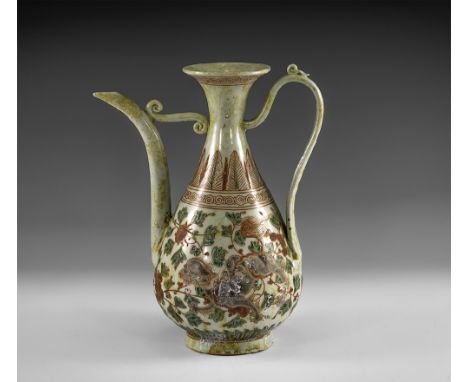 Kangxi Period, Late 17th century AD. A grey-green glazed ceramic vessel with piriform body and flared rim, strap handle to th