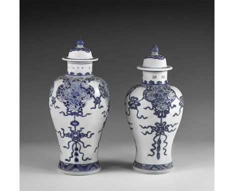 Kangxi Period, Late 17th century AD. A pair of blue and white glazed ceramic meiping vases, each with bell-shaped lid and kno