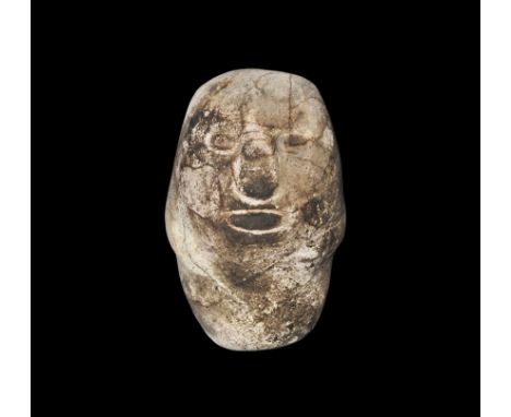 4th century BC. An oval polished stone with carved face features and hands to the both sides. Property of a gentleman; acquir