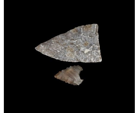 Neolithic, 5th-3rd millennium BC. Group comprising: a large triangular, fully bifacial knapped arrowhead; in a pale brown fli