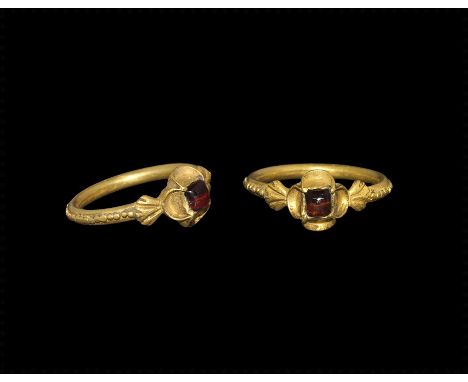 15th century AD. A Gothic or Late Medieval round-section gold hoop with median beaded band to the outer face, florid shoulder