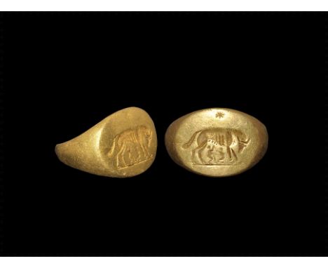 1st century BC-1st century AD. A D-section gold expanding hoop with elliptical plaque, intaglio motif of the she-wolf sucklin