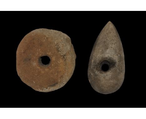 Neolithic, 3rd-2nd millennium BC. A group consisting of a perforated axehead with rounded end and tapered blade, a stone loom