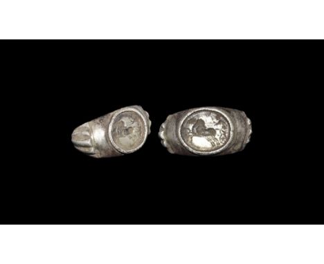 3rd century AD. A silver D-section hoop with radiating ribbed decoration on the expanding shoulders, discoid bezel with beade