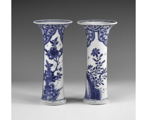 Kangxi Period, Late 17th century AD. A pair of blue and white glazed ceramic beaker vases, each with two panels of flowers an