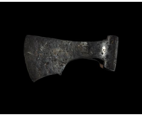 9th-11th century AD. A hand-forged iron axehead with triangular-section blade widening to a broad bevelled edge with square c
