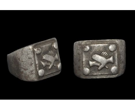 1st-3rd century AD. A silver ring with tapering shank, wide, square shaped, flat bezel with square panel with balls of silver
