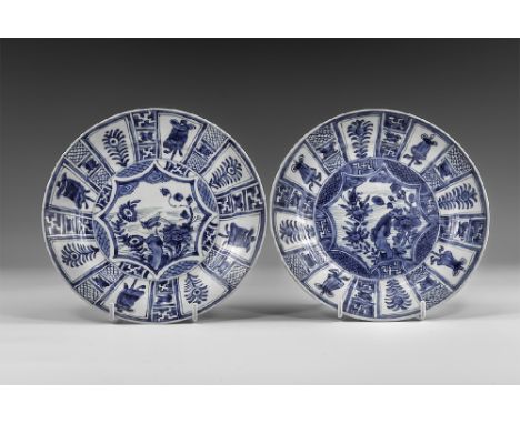 Kangxi Period, Late 17th century AD. A pair of blue and white glazed ceramic dishes with flowers and geometric decoration. Fr