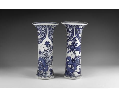 Kangxi Period, Late 17th century AD. A pair of blue and white glazed ceramic beaker vases, each with hatched design to the ri