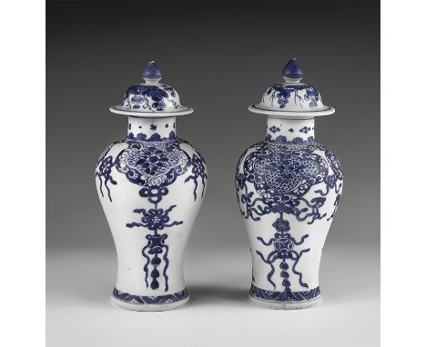 Kangxi Period, Late 17th century AD. A pair of blue and white glazed ceramic meiping bases, each with bell-shaped lid and kno