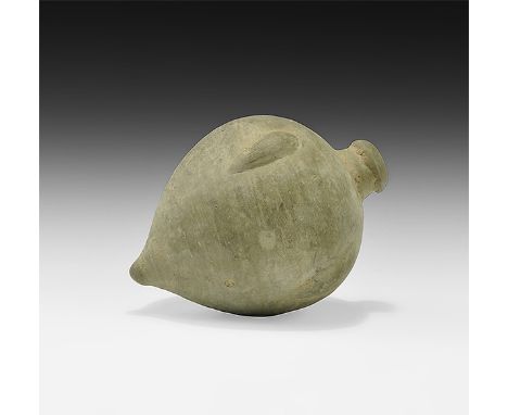 9th-11th century AD. A hollow-formed onion-shaped ceramic vessel with hole and stepped dome to the top, band of arches to the
