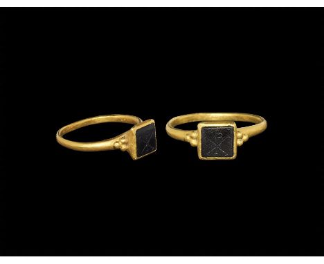 4th-5th century AD. A D-section gold hoop with granules to the shoulders, square cell with inset garnet cloison, chi-rho inta