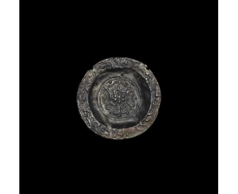 16th-17th century AD. A miniature pewter dish with raised 'Tudor Rose' design to the centre, scrolled foliage to the rim. Fou