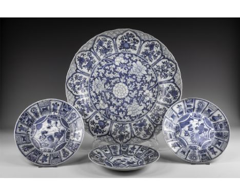 Kangxi Period, Late 17th century AD. A group of blue and white glazed ceramic tableware comprising: a lotus charger with cent