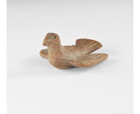 2nd century AD. A terracotta oil lamp formed as a bird with wings and tail spread, filler-hole to the head and nozzle to the 