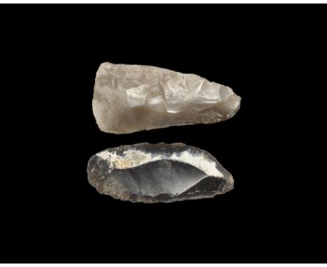 Neolithic, 3rd-2nd millennium BC. Knapped flint tools comprising: a triangular axehead with slightly convex and lightly polis
