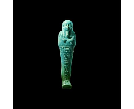 26th Dynasty, 664-525 BC. A pale blue finely modelled glazed composition shabti with tripartite wig, false beard, agricultura