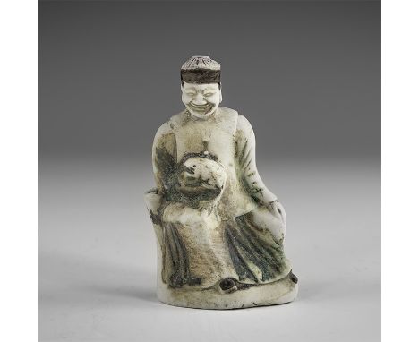 Kangxi Period, Late 17th century AD. A glazed porcelain figure of an elderly man seated and holding a pet in his right hand. 