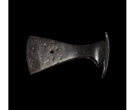 9th-11th century AD. An iron axehead with triangular-section small blade widening to a broad bevelled edge and central hole, 