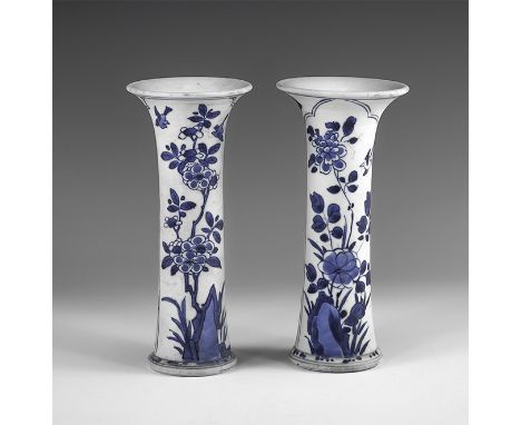 Kangxi Period, Late 17th century AD. A pair of blue and white glazed ceramic beaker vases, each with two panels of flowers, b