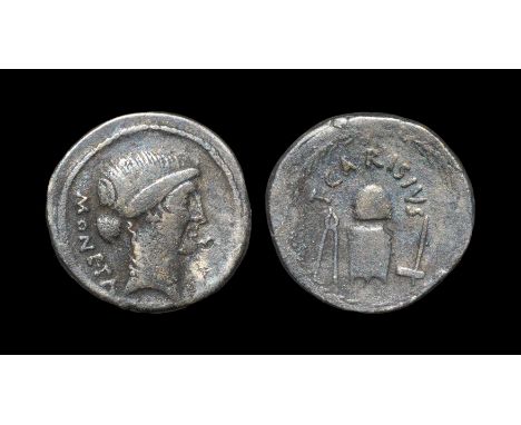 46 BC. Obv: head of Juno Moneta right with MONETA behind. Rev: coin dies (some suggest cap of Vulcan over anvil), between ton