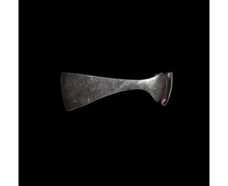 9th-11th century AD. A large hand-forged iron axehead with expanding blade, slightly curved edge, socket with lateral flanges